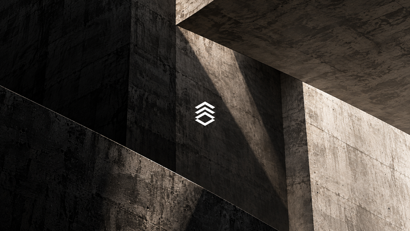 Atlas Surfaces white geometric emblem on dark architectural concrete