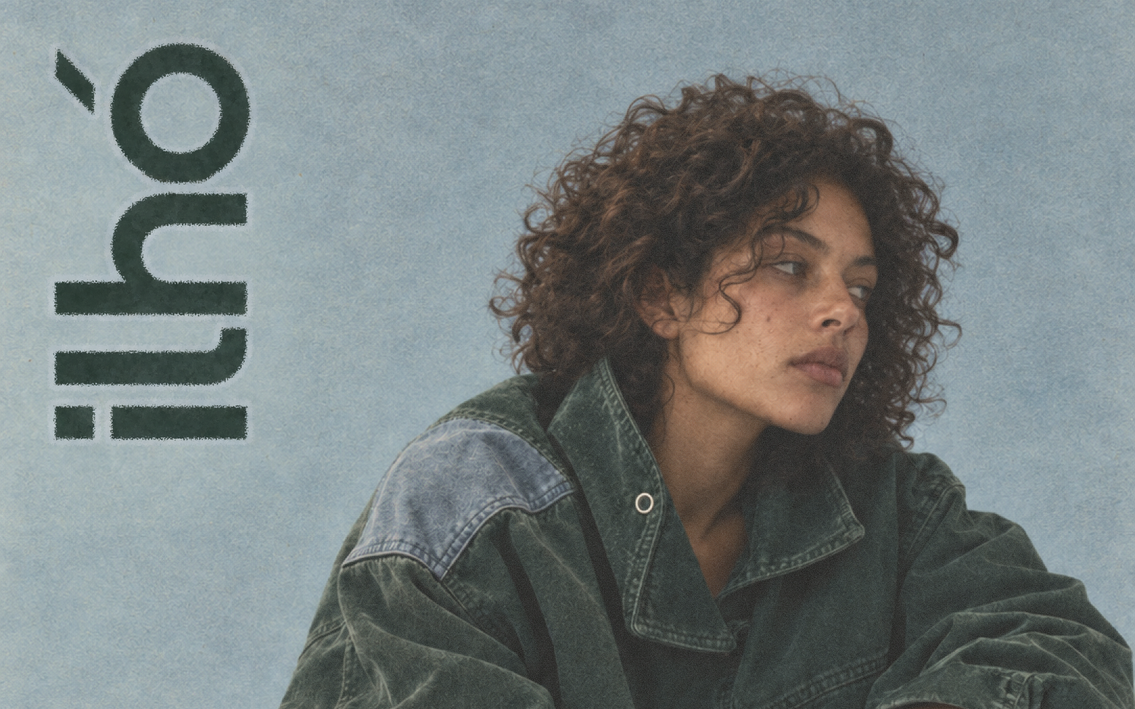 Ilhó streetwear editorial in green and washed blue, with its vertical wordmark